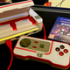 Photo of the Evercade VS retro gaming console, its cartridge slot open with two cartridges installed.